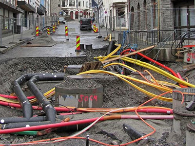 Underground pipes on a wet city street.